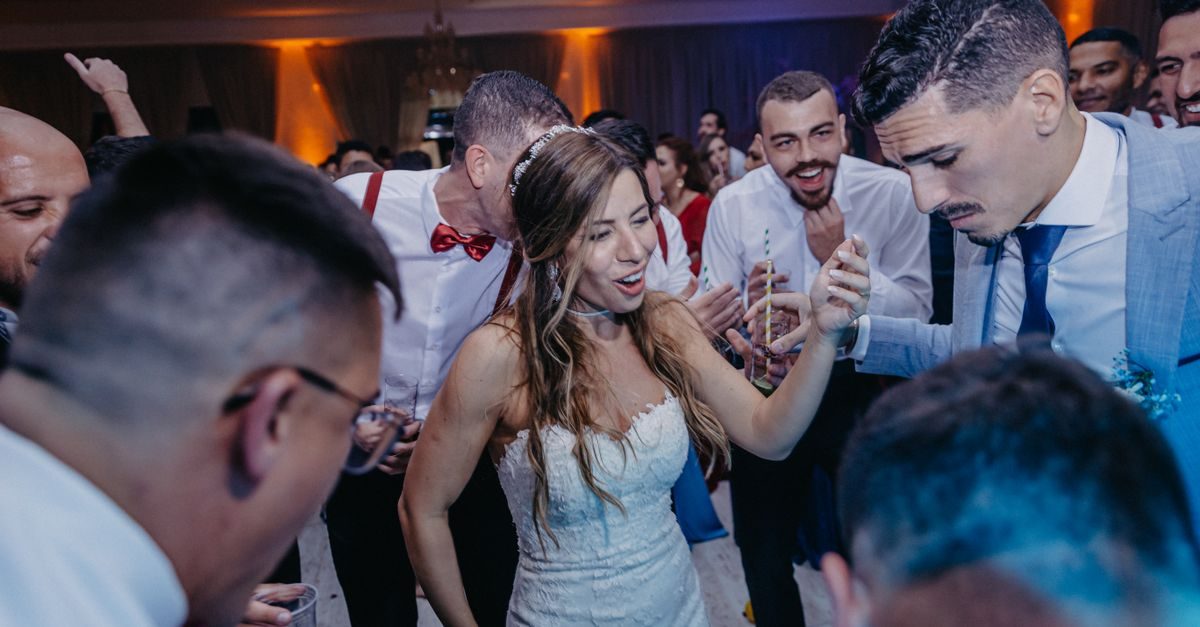 Bride dancing with guests at a wedding reception